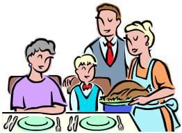 Family gathering around table with roasted turkey.