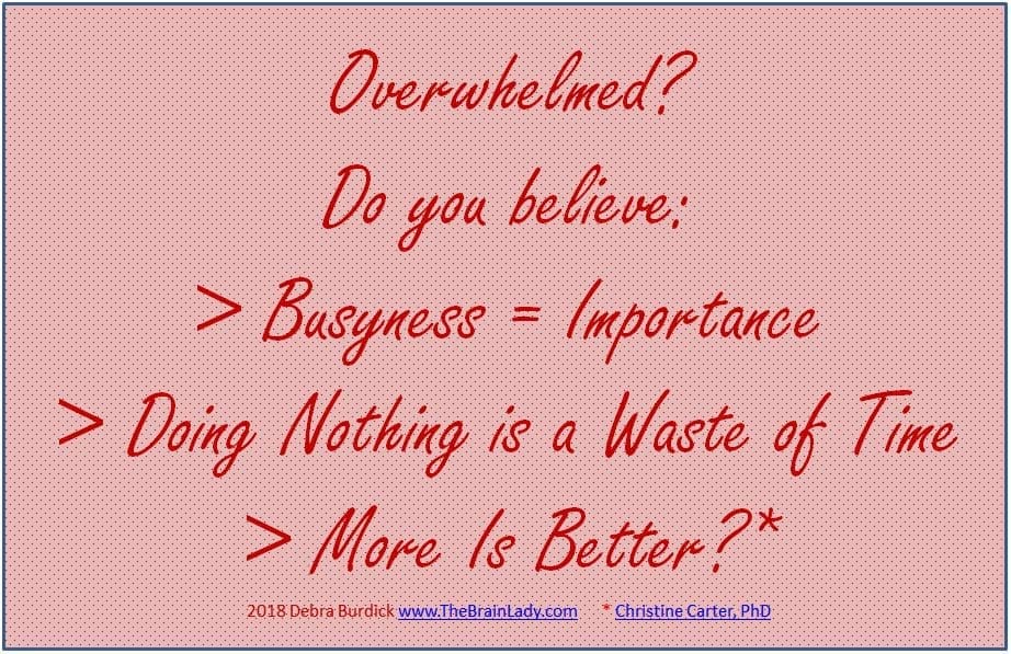 A motivational quote about busyness and doing nothing on a pink background.