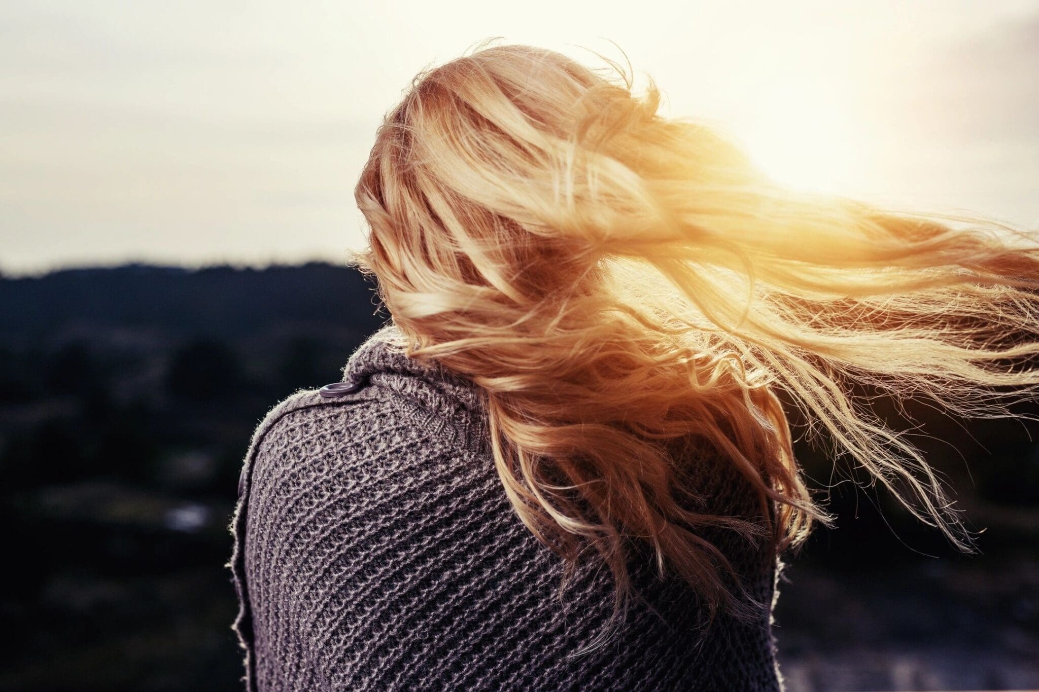 Woman with flowing hair in the sunset.